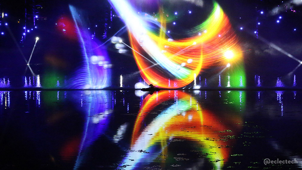 Projected lights over the loch, a huge bright swoosh of red, yellow and white reflected brightly in the lightly rippled loch water.